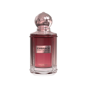 A maroon perfume bottle by Savia Exclusive with a golden cap & white background