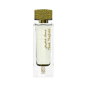 A transparent white perfume bottle by Savia Exclusive with a golden cap