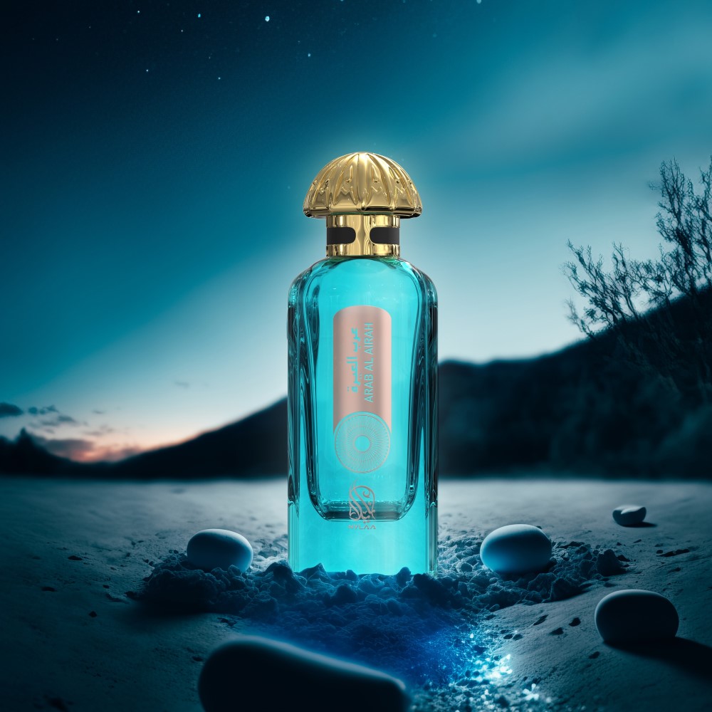 A blue perfume bottle with a golden cap from Nylaa by Savia Exclusive in a starry night on ice with mountains in the background