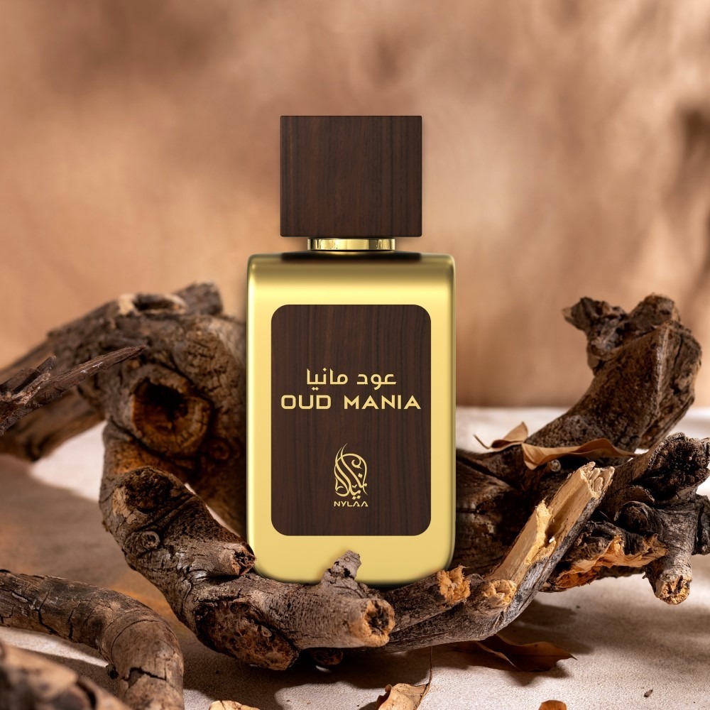 A brown & green perfume bottle poster from Nylaa by Savia Exclusive placed on a brown oak branch