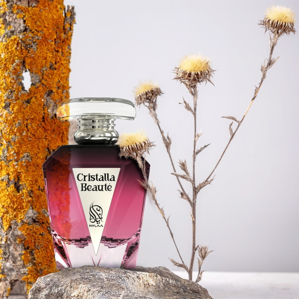 A maroon perfume bottle from Nylaa by Savia Exclusive with yellow flowers