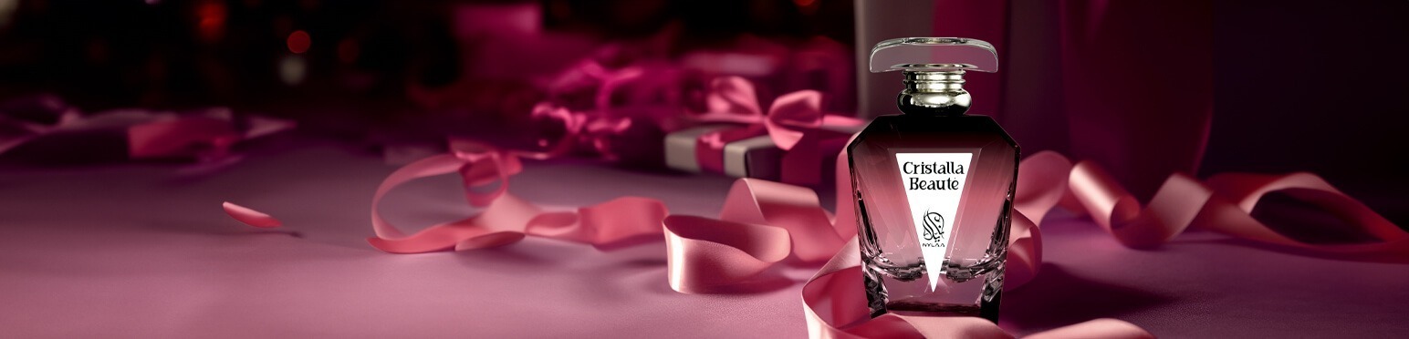 A maroon perfume bottle by Savia Exclusive with maroon ribbons & gift boxes in the background