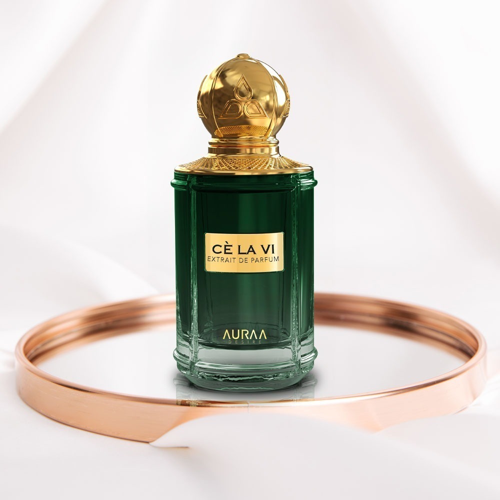 A green perfume bottle by Savia Exclusive in a golden ring circle