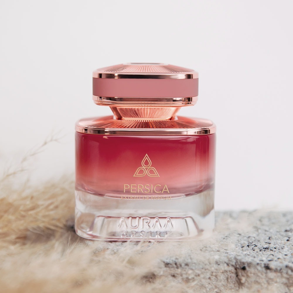 A pink perfume bottle by Savia Exclusive with feathers