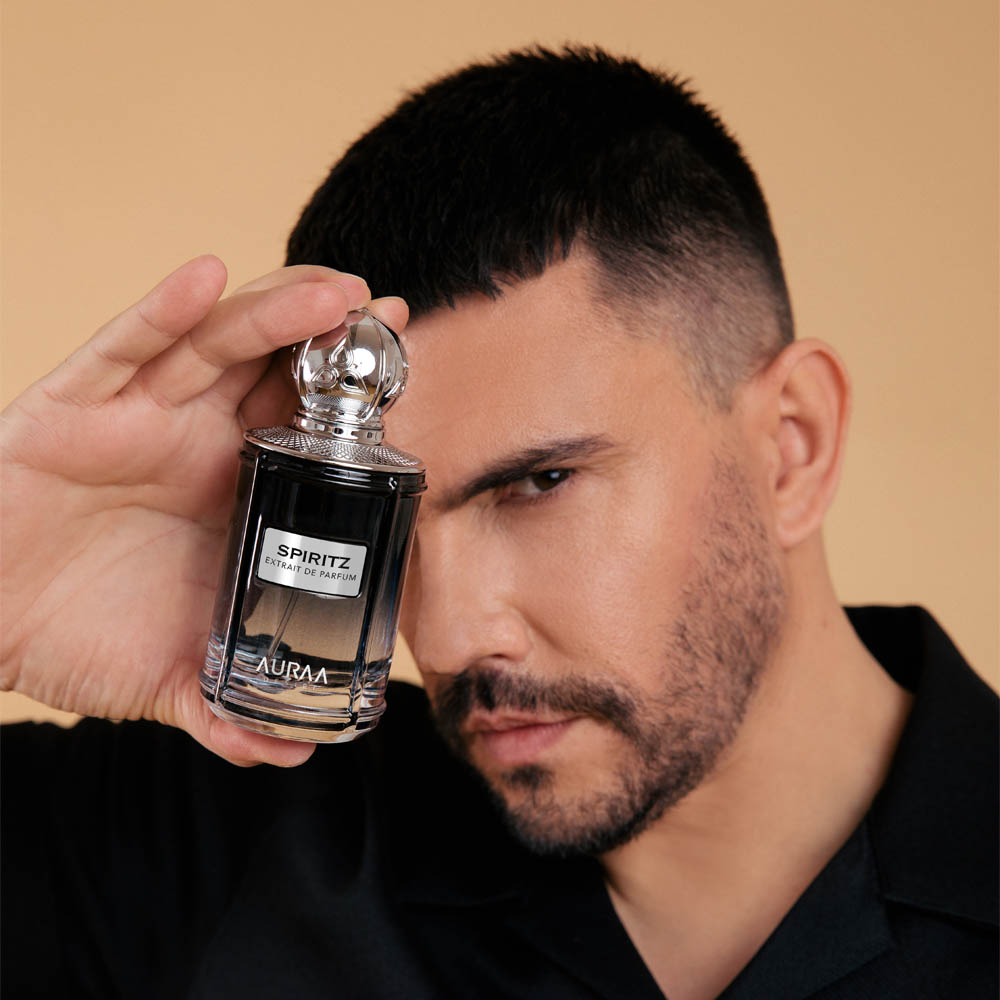 A man holding a black luxury perfume bottle by Savia Exclusive