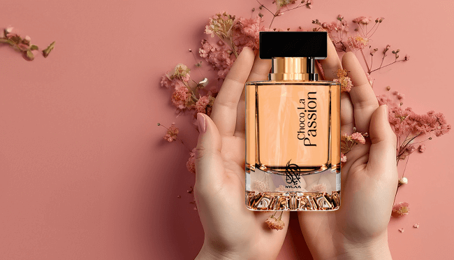 A perfume bottle by Savia Exclusive with a pink floral background